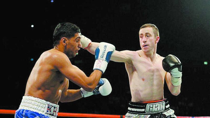 Paul McCloskey catches Amir Khan in their WBA World Light-Welterweight title rumble at the in Manchester in 2011 