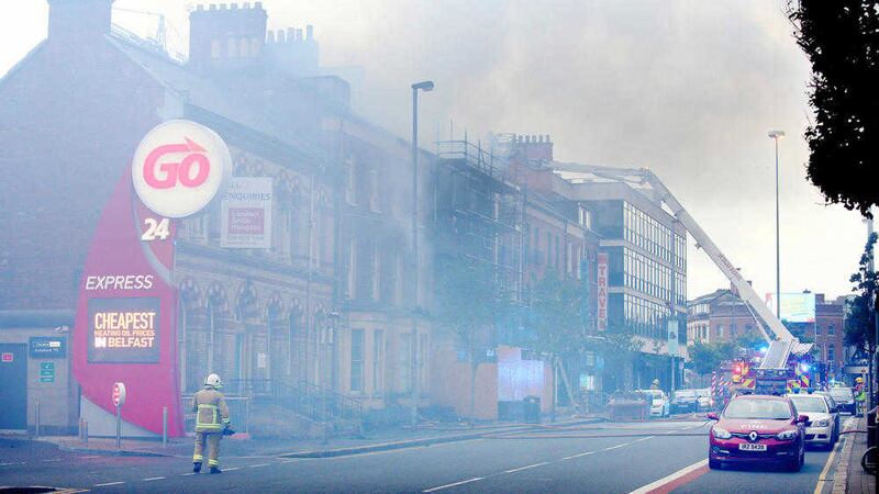 Smoke billows from a building on Great Victoria Street in Belfast, close to a petrol station, as firefighters attempt to bring the blaze under control. Picture by Cliff Donaldson 