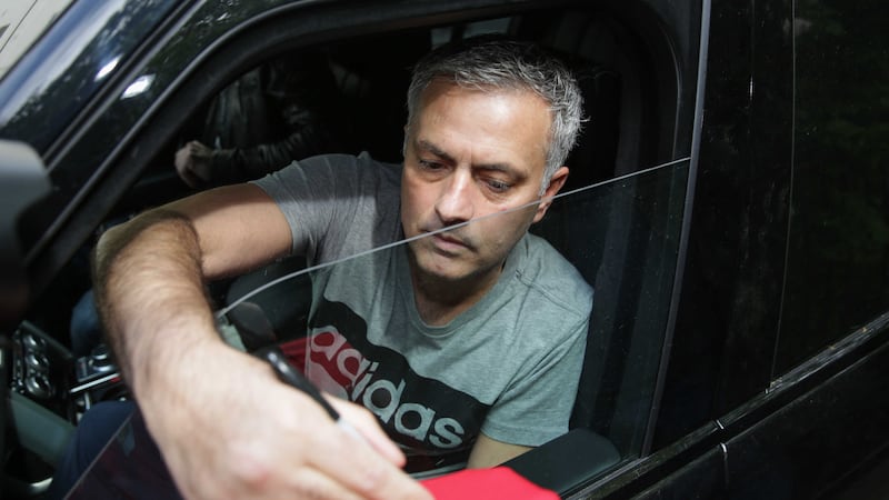 New Manchester United manager Jose Mourinho signs a fan's shirt outside his home in central London on Friday<br />Picture by PA&nbsp;