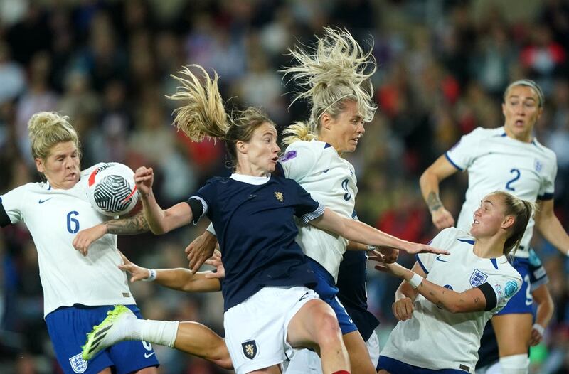 England’s Rachel Daly, centre right, and Scotland’s Erin Cuthbert battle for the ball