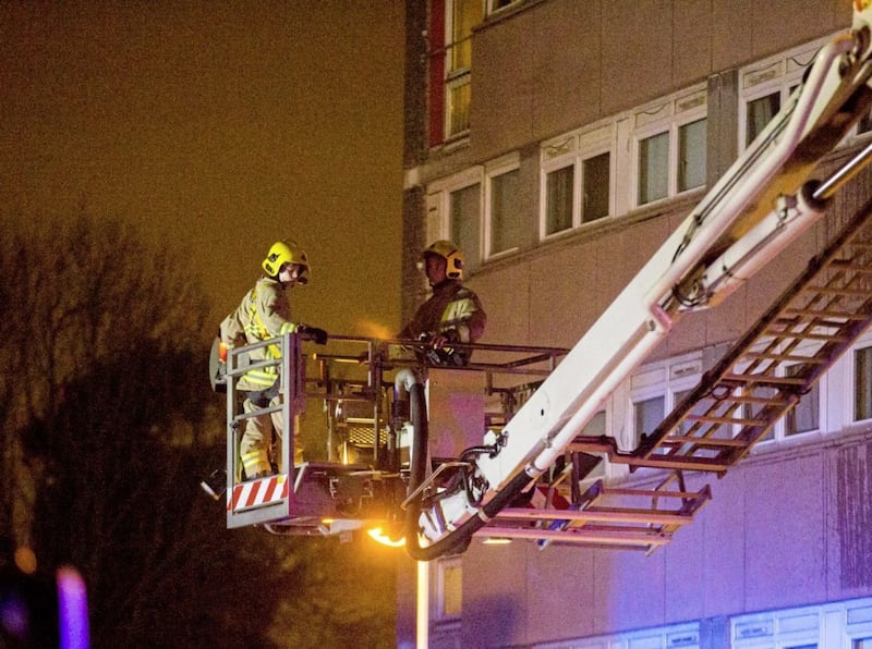 Firefighters at the scene of a fire at Coolmoyne House in Dunmurry, near Belfast, where residents have been evacuated from the building. Liam McBurney/PA Wire...