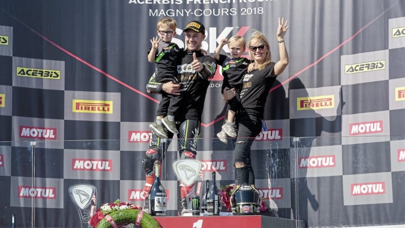World champion Jonathan Rea celebrates with his wife and children on the podium at Magny-Cours, France 