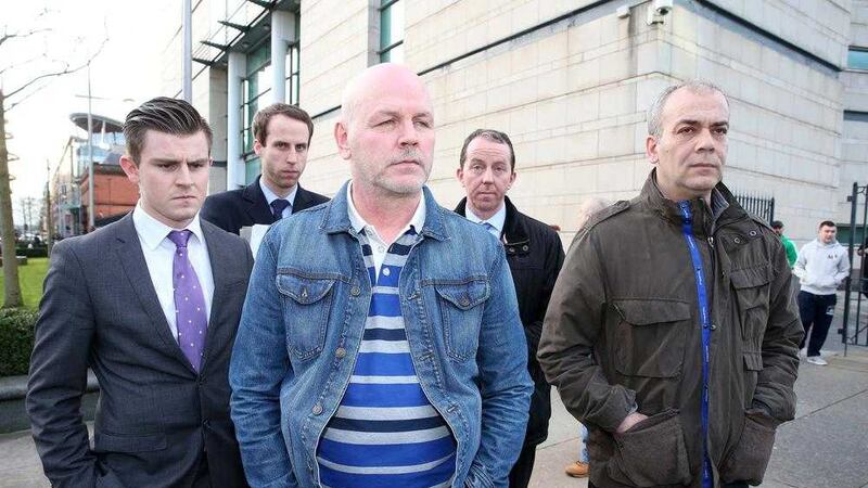 Alex McCrory (centre) and Colin Duffy (far right) leave court last month after being released on bail. Picture by Mal McCann 