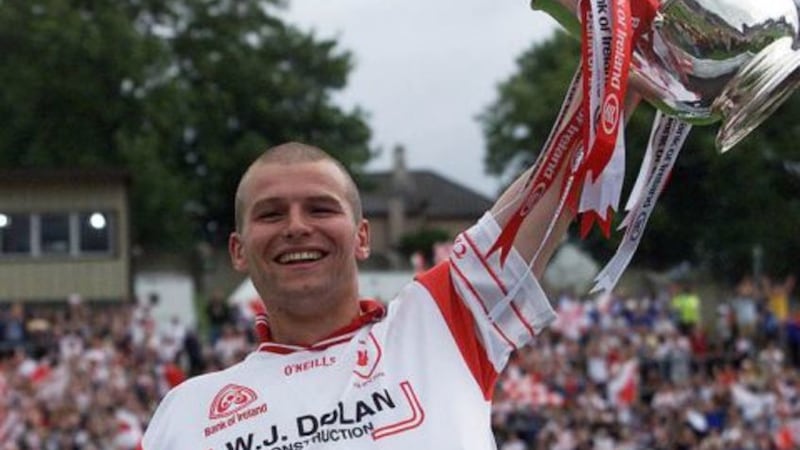 Tyrone captain Sean Teague lifts aloft the Anglo-Celt Cup, one-handed, after the 2001 Ulster Final in Clones.