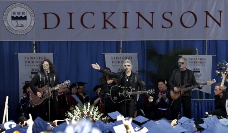 Musician Jon Bon Jovi, top center, performs with his band during a surprise appearance at the Fairleigh Dickinson University commencement ceremony