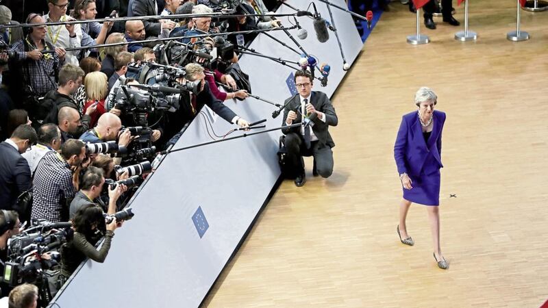 Theresa May walks away after speaking with the media during arrival for an EU summit at the Europa building in Brussels PICTURE: Alastair Grant/PA 