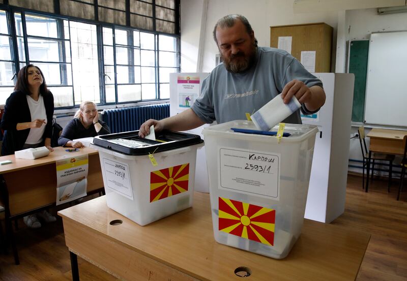 A man casts his ballots for the parliamentary election and the presidential runoff, at a polling station in Skopje, North Macedonia (Boris Grdanoski/AP)