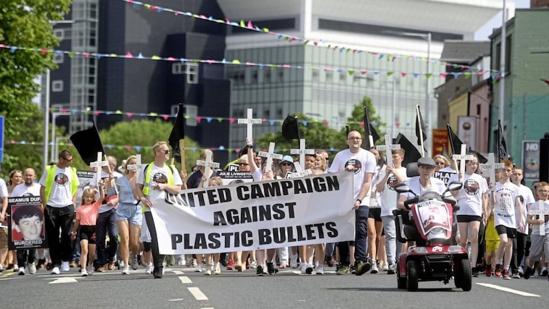 Members of the United Campaign Against Plastic Bullets and supporters march towards Islandbawn Street in west Belfast. Picture by Mark Marlow 