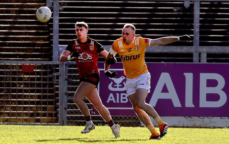 Down's  Shealan Johnston  in action with  Antrim's Marc  Jordan in Saturday night's Ulster Championship game at Páirc Esler           Picture: Seamus Loughran