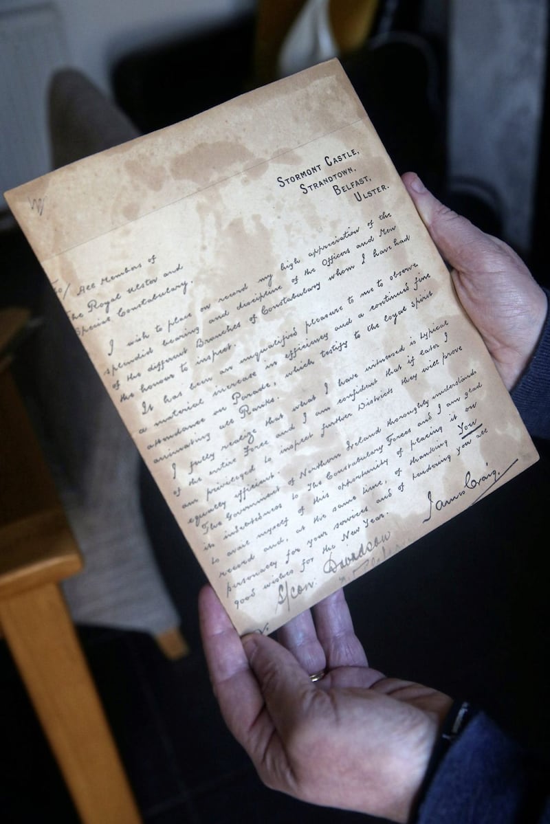 Laurence Kennedy with the letter he found from former  Prime MInster James Craig that was hidden behind a picture of the Sacred Heart which had been passed down through the family. Picture Mal McCann. 