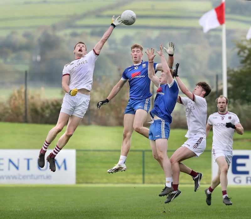 Slaughtneil's Brendan Rogers claims the incoming ball ahead of Oisin McErlean of Bellaghy Picture: Margaret McLaughlin