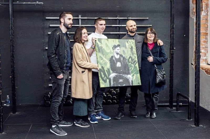 Michael Cullen's brothers Danny (in black) and Colm with his sister Cathy, mum Rosemarie and friend Rory Girvan at the launch of the 33 Til Infinity campaign last December, with a painting of Michael by artist Niall Smyth