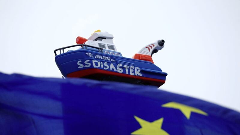 A toy boat held aloft by anti-Brexit protester Steve Bray outside Parliament in Westminster, London Picture by Yui Mok/PA 