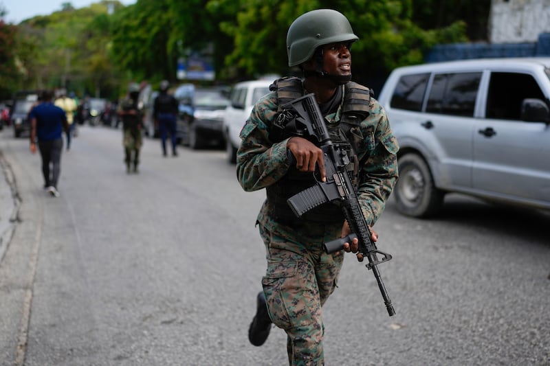 Soldiers deploy outside the Prime Minister’s office in Port-au-Prince, Haiti (Ramon Espinosa/AP)
