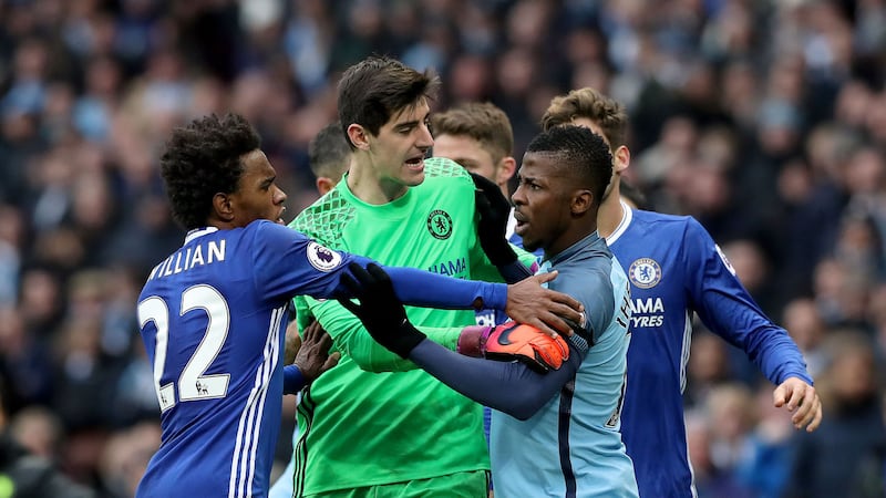 Chelsea goalkeeper Thibaut Courtois (centre), Chelsea's Willian (left) and Manchester City's Kelechi Iheanacho get involved after Manchester City's Sergio Aguero (not in picture) fouled Chelsea's David Luiz (not in picture) during the Premier League match at the Etihad Stadium&nbsp;