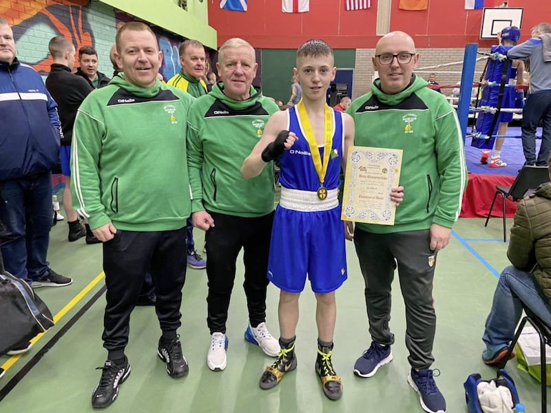 Holy Trinity&#39;s Kyle Smith celebrates his Ulster title win in Newry at the weekend. He is pictured with club coaches Michael Hawkins, Ciaran Scullion (left) and Robert Fisher (right) 