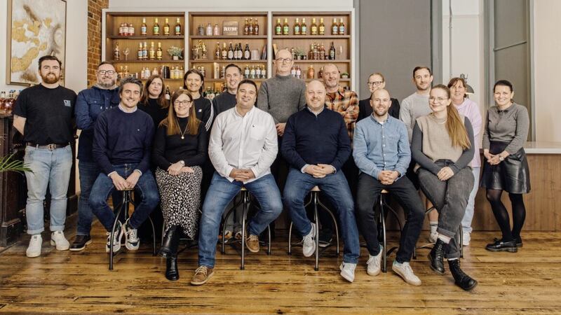 Ryan McFarland, chief strategy &amp; commercial officer (front and centre left) and Steven Pattison, CEO and co-founder (front and centre right), with some of the DKG team in their Belfast HQ. 