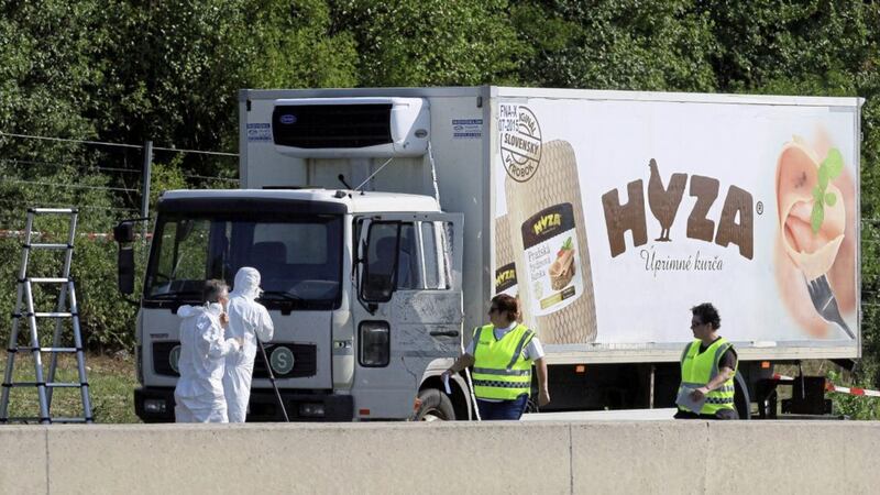 Investigators stand near an abandoned truck on the shoulder of Highway A4 near Parndorf, Austria, south of Vienna. Officials said they discovered 71 badly decomposed bodies of men, women and children, inside and that some may never be identified. Picture by Ronald Zak,file, Assocaited Press 