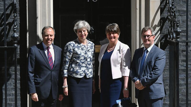 British Prime Minister Theresa May greets DUP leader Arlene Foster, DUP deputy leader Nigel Dodds and MP Sir Jeffrey Donaldson outside 10 Downing Street in London earlier this year ahead of talks aimed at finalising a deal to prop up the minority Conservative government&nbsp;