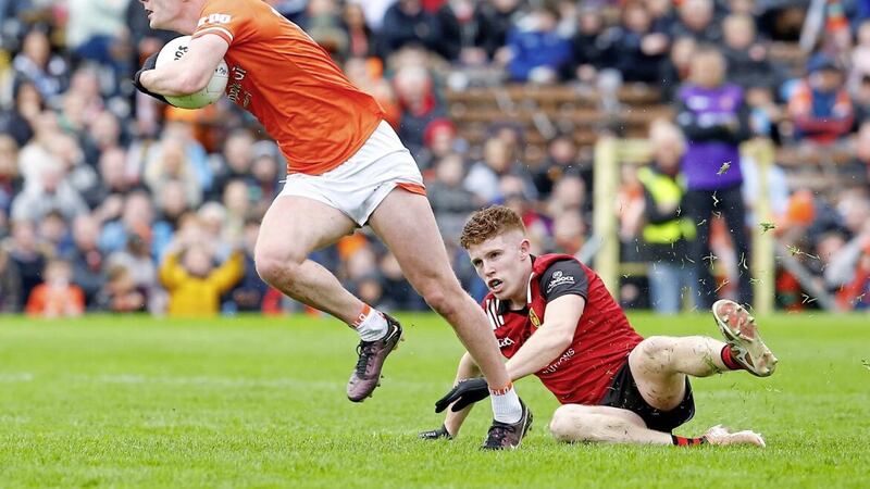 Down&#39;s Ross Carr is left for dead by Armagh&#39;s Ross McQuillan during Sunday&#39;s Ulster SFC semi-final in Clones Picture by Philip Walsh 