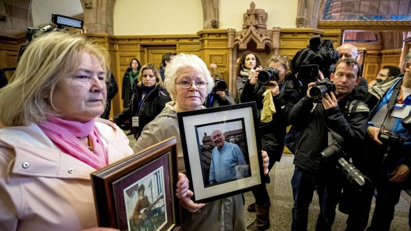 L-R Linda Nash, holds an image of their brother William Nash who was killed on Bloody Sunday, and Kate Nash holds an image of their father Alex Nash who was wounded on the day