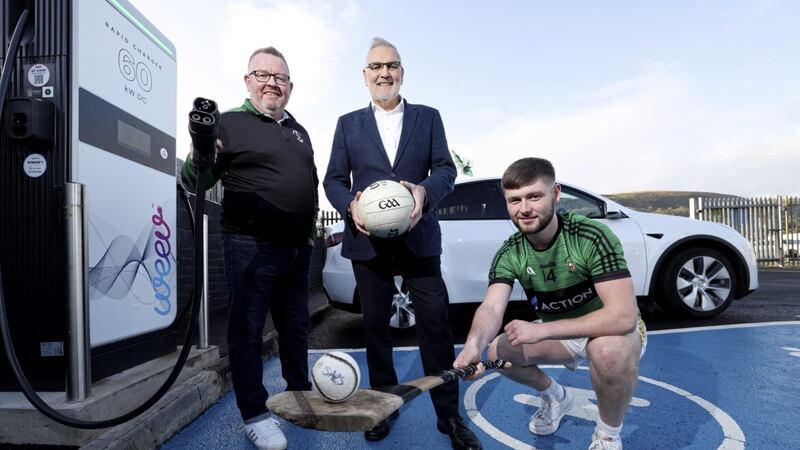 Weev has installed its first sports club charger at Patrick Sarsfield GAA club in west Belfast. Weev chief executive Philip Rainey (centre) is pictured with Patrick Sarsfield chair Eamon McGarrigle and player Anthony McGarrigle. Picture: Matt Mackey/PressEye 