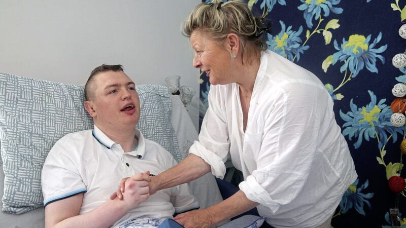 Jean Kelly with her son Deaglan in a specially built extension in their west Belfast home. Deaglan suffers from severe epilepsy and his family are trying to get a licence for cannabis oil to treat him. Picture by Mal McCann 