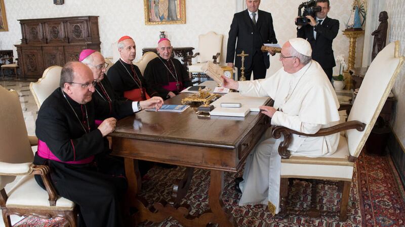 Pope Francis sits at a table with, from left, Monsignor Mario Antonio Cargnello, Archbishop Jose Maria Arancedo, Cardinal Mario Poli, and Monsignor Carlos Humberto Malfa, on the occasion of his meeting with the Argentine Episcopal Conference. Picture by L&#39;Osservatore Romano, Pool Photo via Associated Press 