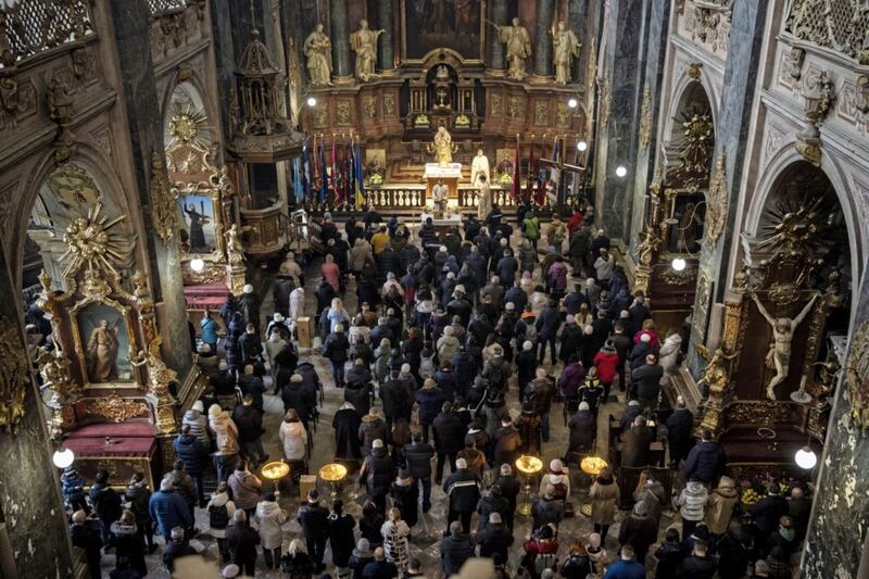 Worshippers attend Mass in the Saints Peter and Paul Garrison Church in Lviv, western Ukraine on Sunday. Picture by AP Photo/Bernat Armangue. 