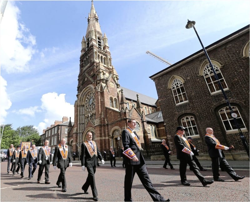 &nbsp; Orange bands passed St Patrick's Church on Donegall St with just a single drum beat. Picture: Hugh Russell.