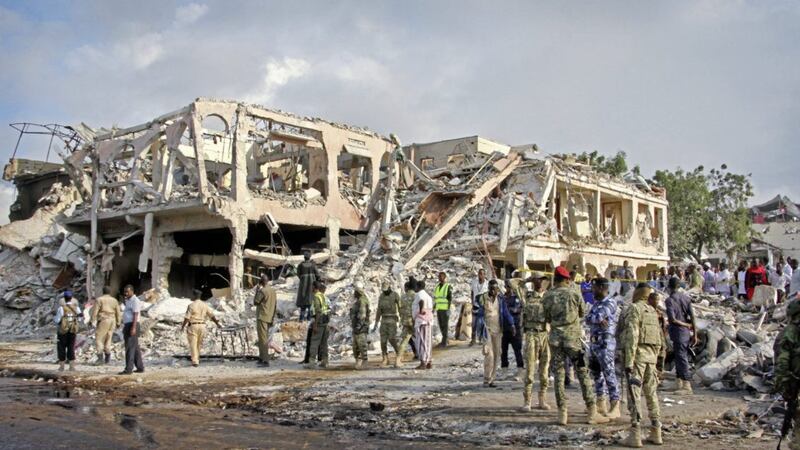 Somali security forces and others gather and search for bodies near destroyed buildings at the scene of Saturday&#39;s blast, in Mogadishu. Picture by Farah Abdi Warsameh, Associated Press 