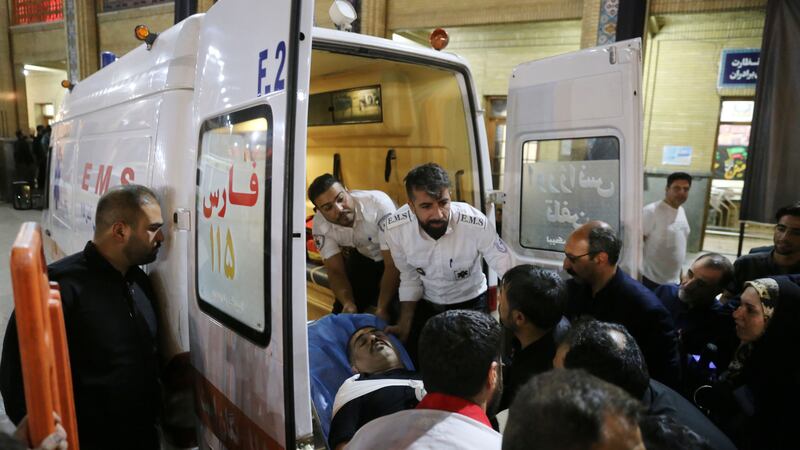 Medics carry a wounded man into an ambulance (Reza Ghaderi, IRNA via AP)