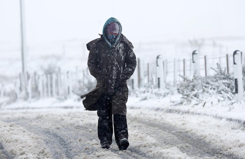 A Women battles threw the snow on Divis Mountain with snow falls across Ireland.
PICTURE: COLM LENAGHAN