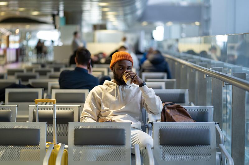 Man drinking coffee at airport