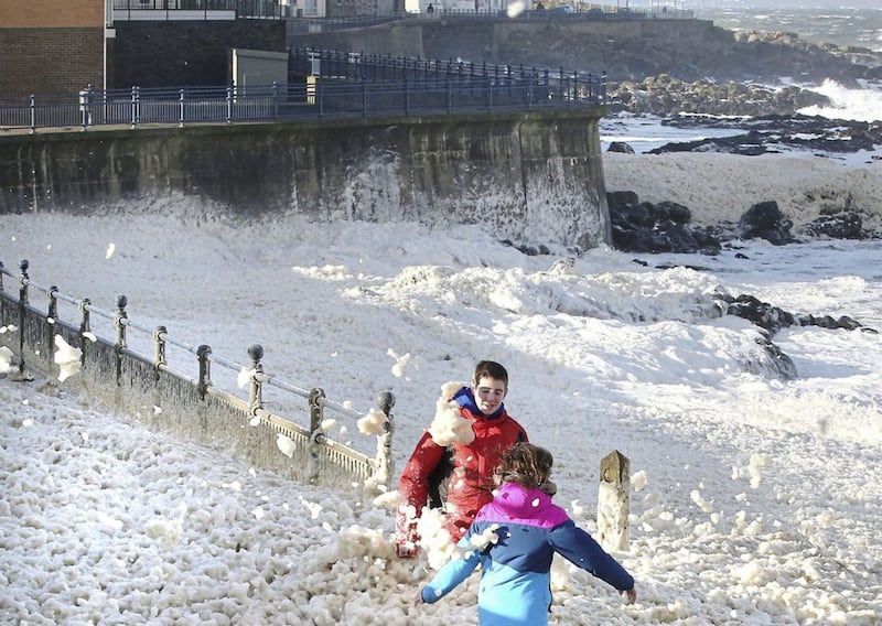 Foam from sea waves arrives on shore along the promenade in Portstewart during windy weather on Sunday. Picture by Margaret McLaughlin 