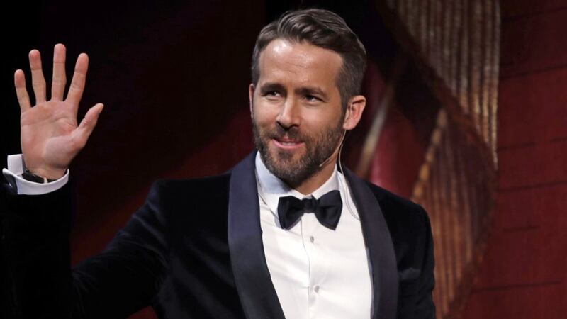 Man Of The Year Ryan Reynolds dons a bra to collect gong