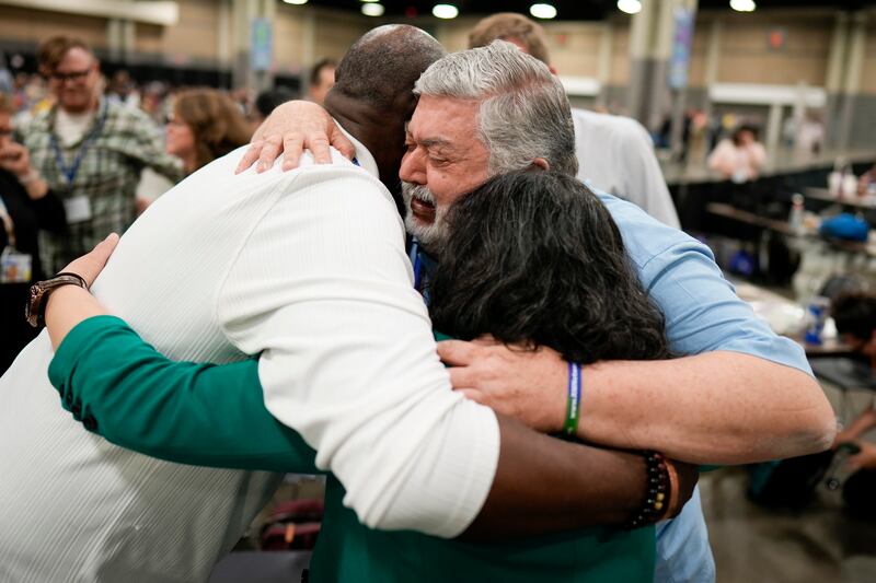 Observers hug after the approval vote at the United Methodist Church General Conference on Wednesday in Charlotte, North Carolina (Chris Carlson/AP)