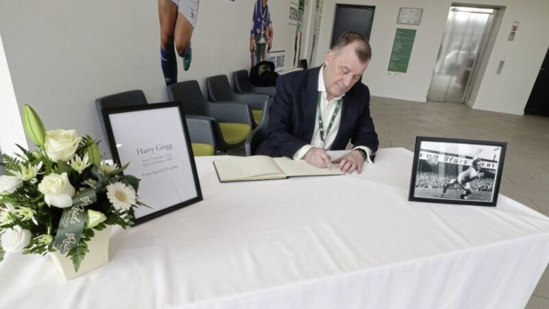 IFA chief executive Patrick Nelson signs the book of condolences for the late Harry Gregg at Windsor Park.  