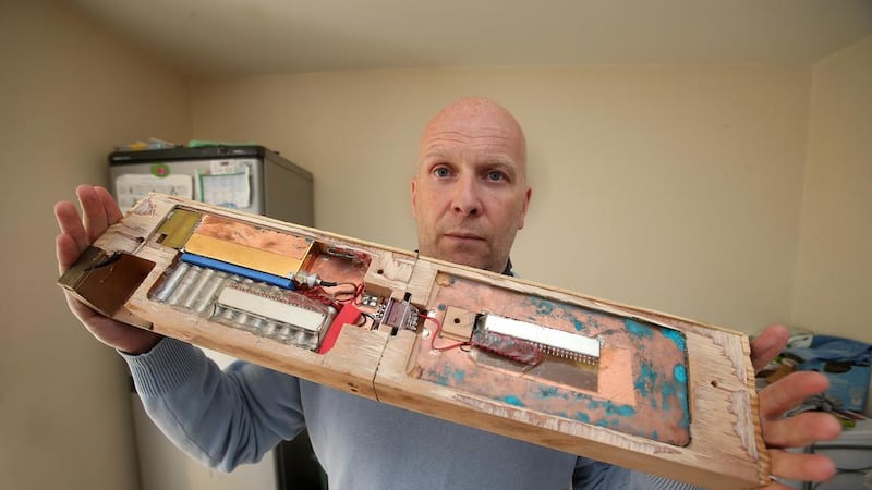 North Belfast republican Terry McCafferty with the bugging equipment he discovered attached to wooden joists in his ceiling. Picture by Mal McCann 