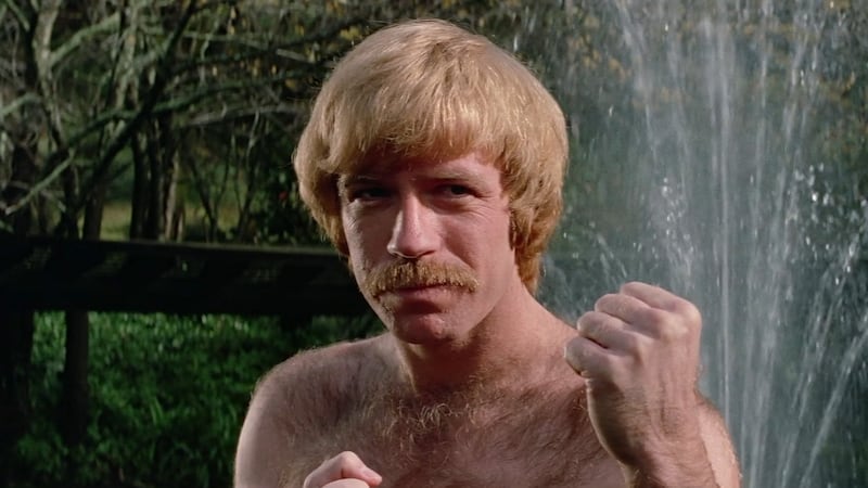 A photo of a bare-chested Chuck Norris preparing to beat someone to a pulp as Chuck Slaughter in Slaughter in San Francisco