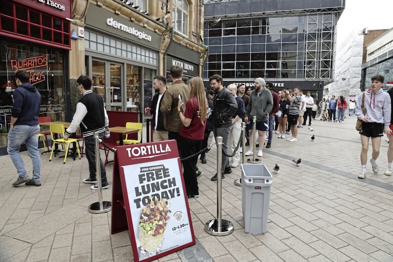 Customers queued outside Tortilla&#39;s new Belfast venue on Arthur Square. Picture by Hugh Russell. 