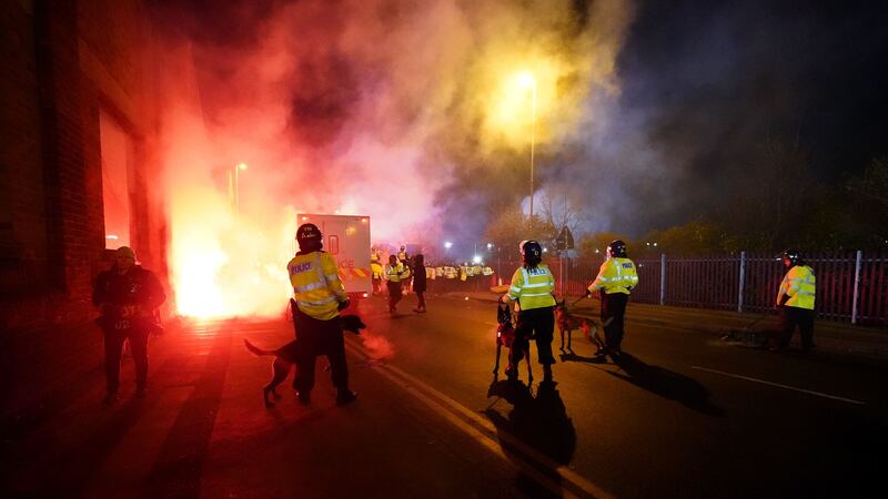 Police attempt to put out flares that have thrown towards them outside the stadium before the UEFA Europa Conference League Group E match at Villa Park, Birmingham. Picture date: Thursday November 30, 2023.