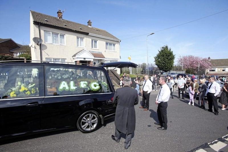 Family and friends pay their last respects to Alec Fitzpatrick who died from Covid 19 in a west Belfast Nursing home at the weekend. Picture Mal McCann.