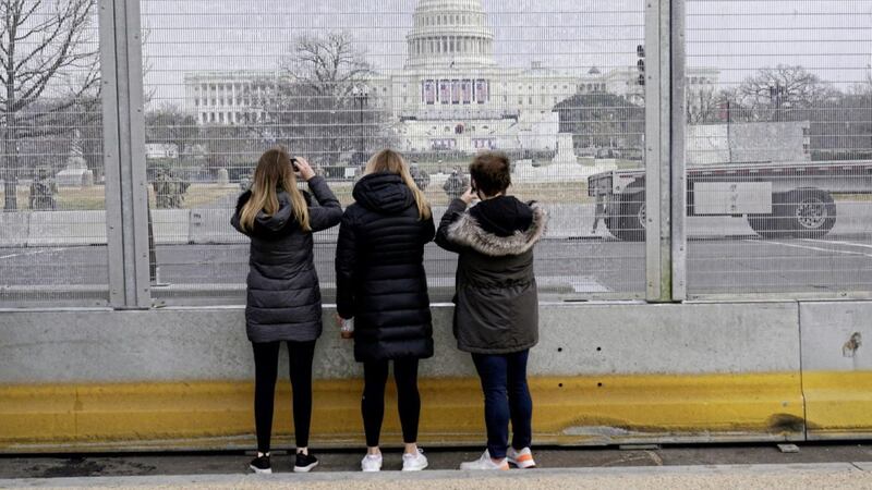 THROUGH THE BARRICADE: Tourists grab pictures of Capitol Hill following the inauguration of Joe Biden, whose presidency is likely to have an impact on both the economy and ESG 
