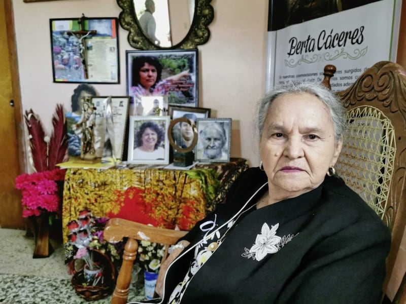 Austra Berta Flores sits beside a shrine to her murdered daughter Berta C&aacute;ceres at her home. The circular Goldman Environmental Prize can be seen on the table in the background. Picture from Tr&oacute;caire