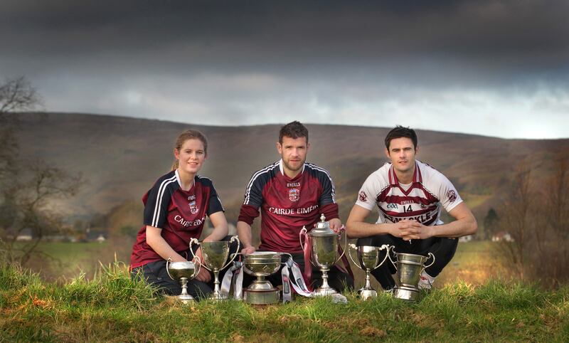 At the foot of Carntogher Mountain, Slaughtneil GAC's historic triple Ulster Senior Championship captains, Aoife Ni Chaiside, Francis McEldowney and Chrissy McKaigue with the recently collected silverware as Derry and Ulster Champions. Picture Margaret McLaughlin  &nbsp;