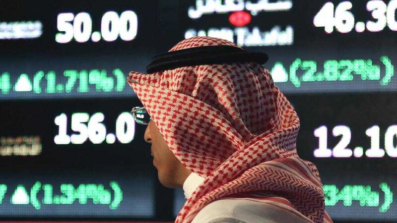 A Saudi man walks at the Tadawul Saudi Stock Exchange, in Riyadh, Saudi Arabia. Picture by Hasan Jamali, Associated Press