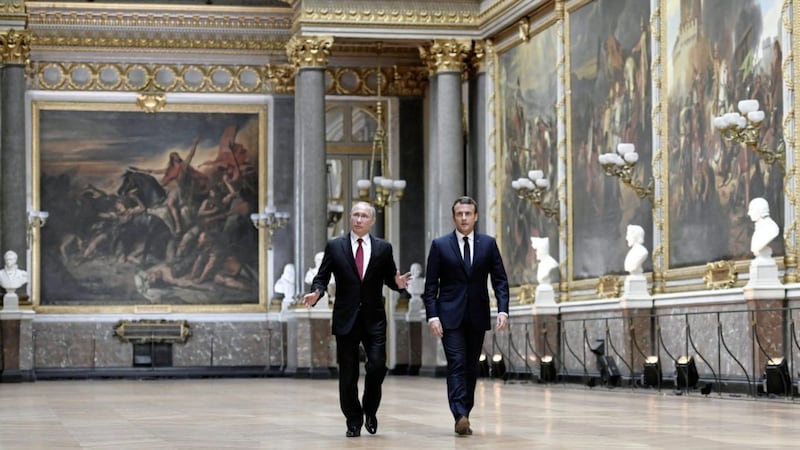French President Emmanuel Macron, right, and Russian President Vladimir Putin walk in the Galerie des Batailles (Gallery of Battles) at the Versailles Palace as they arrive for a joint press conference following their meeting in Versailles yesterday. Picture by Stephane de Sakutin Pool Photo via Associated Press 