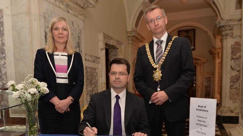 Secretary of State James Brokenshire signs a book of condolence in Belfast City Hall with Lord Mayor Brian Kingston and chief executive of Belfast City Council Suzanne Wylie. Picture by Belfast City Council/Press Association