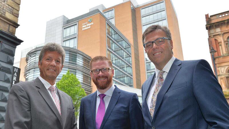 Economy Minister Simon Hamilton (centre) with Invest NI chairman Mark Ennis (left) and chief executive Alastair Hamilton 